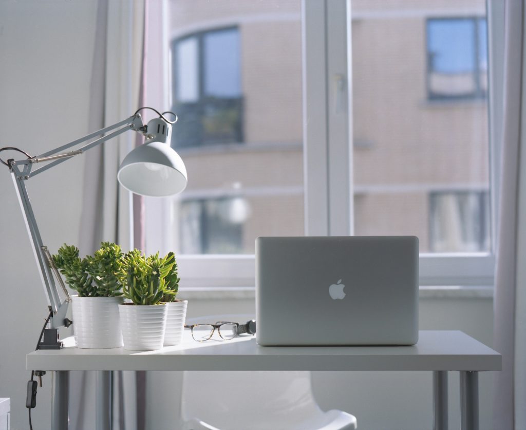 Silver Macbook Air and Goose Neck Lamp